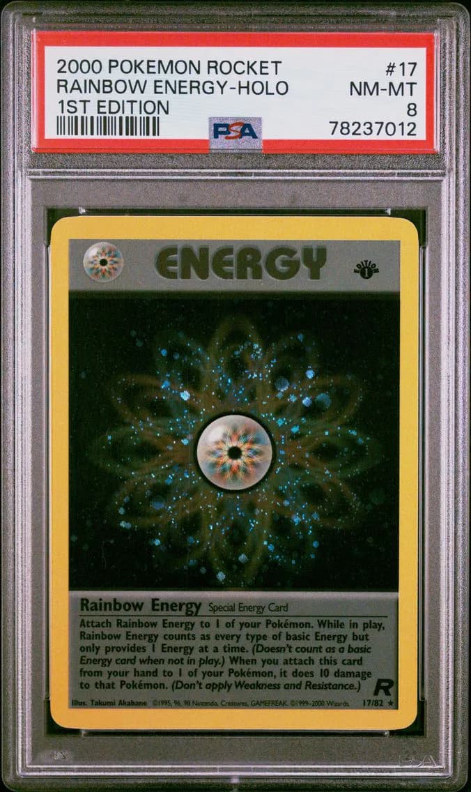Rainbow Energy-Holo 1st Edition, Rocket, PSA 8